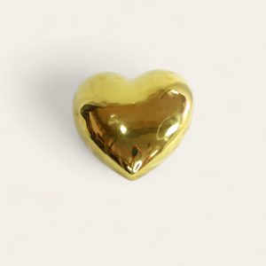 Corazón decorativo de porcelana de color dorado.