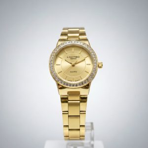 Reloj de pulsera de cuarzo analógico para mujer en tono dorado con un bisel tachonado de cristales.